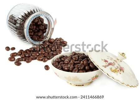 Chocolate dragee in a glass jar and in a Porcelain box isolated on a white background. Collage. Free space for text. Royalty-Free Stock Photo #2411466869