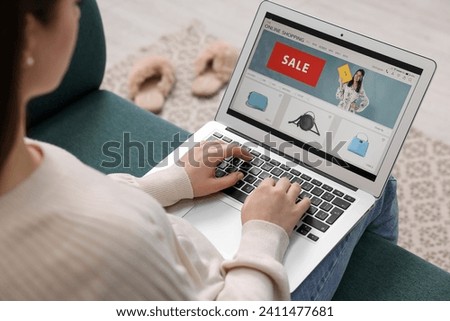 Woman shopping online during sale on laptop at home, closeup