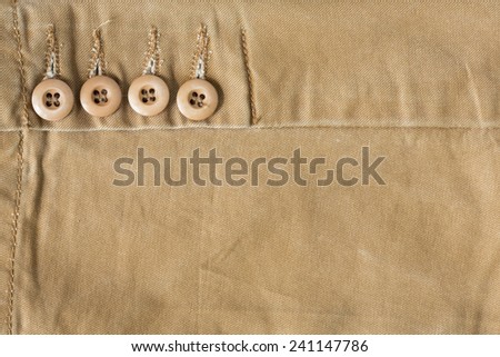 design botton of brown shirt on fabric textile background