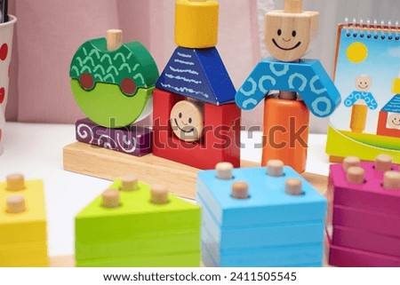 Children's toys. Logic game for kids. Happy child and fun Games. Day and Night is a fun-filled game of logic. Colourful wooden blocks. Bricks with the pyramid. High quality photo