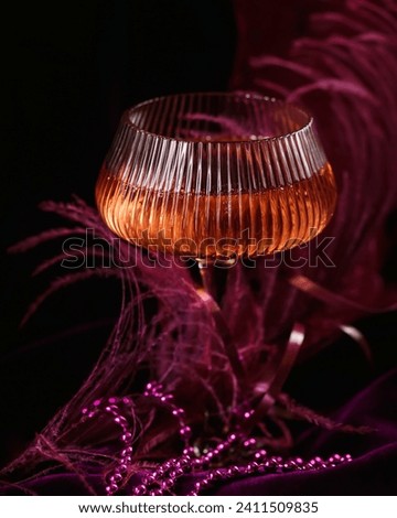 Extravagant glamour background with glass of sparkling wine for love party at muffled light. Beautiful romantic burlesque place for valentines holiday Royalty-Free Stock Photo #2411509835