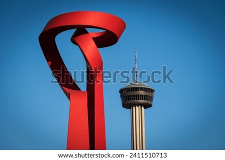 Tower of the Americas and Torch of Friendship statue in San Antonio, Texas