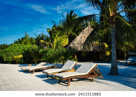 Lounge chairs on the beach in Mexico Caribbean sea Royalty-Free Stock Photo #2411511883