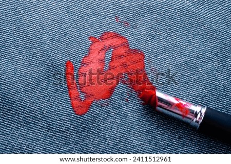 Dirty stain of lipstick on the carpet or sofa upholstery. daily life stain concept. top view. High quality photo