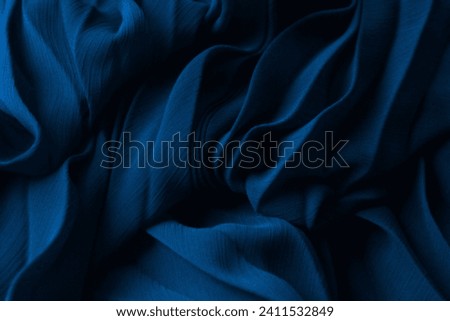Elegant dark blue silk fabric. Aesthetic aquamarine tissue texture, cyan folded dress textile background. Ocean dunes, luxurious pleated chiffon clothing, indigo 3d abstract sea waves
