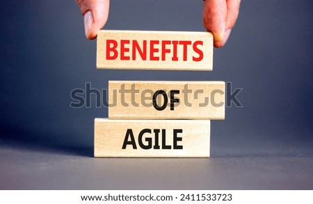 Benefits of agile symbol. Concept words Benefits of agile on beautiful wooden blocks. Beautiful grey table grey background. Businessman hand. Business benefits of agile concept. Copy space. Royalty-Free Stock Photo #2411533723