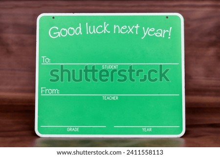 A decorative sign wishing the graduate good luck