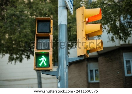 Pedestrian Crossing green light - Yellow Painted Traffic Signal on Steel Pole in Barcelona, Spain . High quality photo