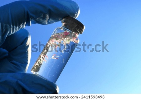 Collecting water samples contaminated with microplastics, plastic pollution  Royalty-Free Stock Photo #2411593493