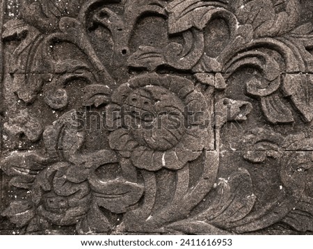 photo of ancient flower carvings on old -aged stones
