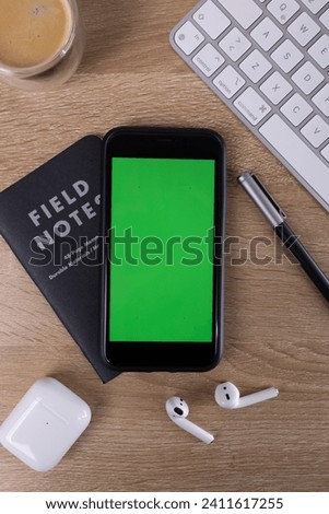 Home office scenery smarphone notepad pencil keyboard earphones green screen