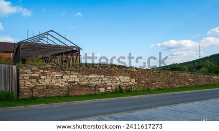 An old abandoned brick factory against a bright sky