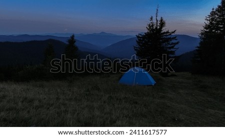 Tent on the background of the sunset in the Carpathian mountains. Ukraine