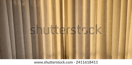 "Radiant and welcoming, this sunlit house curtain creates a warm and inviting atmosphere. Purchase this image and illuminate your projects with luminosity and comfort!" Royalty-Free Stock Photo #2411618411