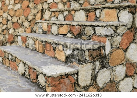 Textured old stone stairs with brick pattern in daylight. Great for background Royalty-Free Stock Photo #2411626313