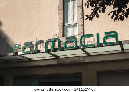 Sunlit summer evening at the pharmacy - a charming metal and glass awning proudly displays the 'pharmacy' sign above the storefront.