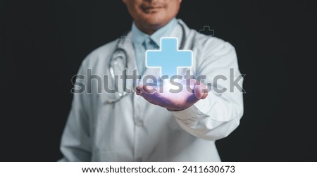 Mental health care mental rejuvenation concept. Doctor Man smiling good mood hand holding virtual blue plus sign for positive thinking mindset or healthcare insurance symbol. social security. check-up Royalty-Free Stock Photo #2411630673
