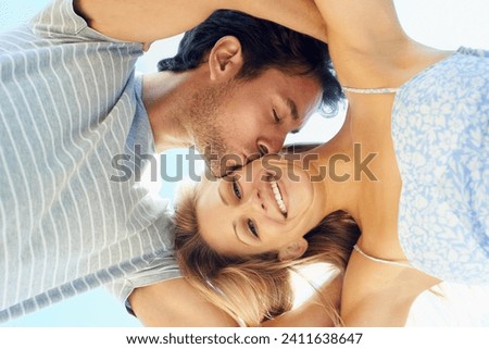 Kiss, portrait or happy couple hug in outdoor on date for support or love in nature together. Low angle, romantic man or woman with joy or smile on holiday vacation for fun bond, travel or wellness