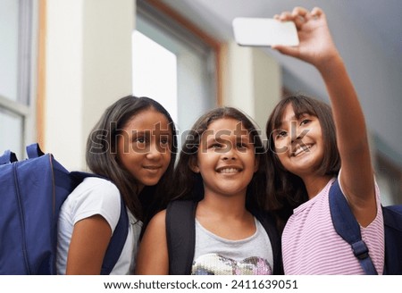 Friends, children and smile for selfie in elementary school lobby for fun educational memory together. Group of students, young girls and kids taking picture for social media, photography or learning