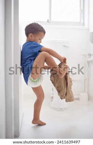 Child, bathroom and toilet training for learning growth, milestone or hygiene. Male person, kid diaper and pants or step for development in home for parent care for toddler teaching, health or love Royalty-Free Stock Photo #2411639497