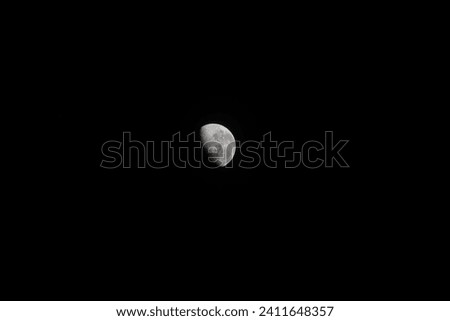 portrait of the moon shining at night against the dark background of a starless night