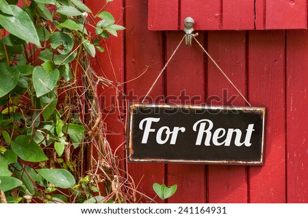 Old metal sign with the inscription For Rent Royalty-Free Stock Photo #241164931