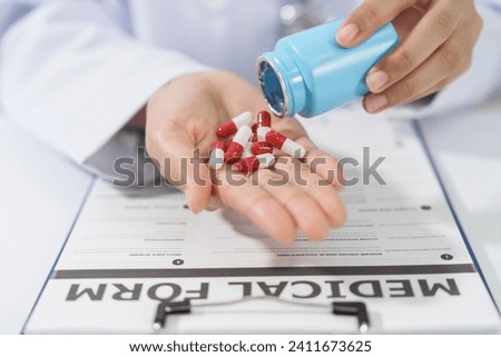Specialist medical professionals check the quality and expiration date of the vials and medicine capsules. Royalty-Free Stock Photo #2411673625