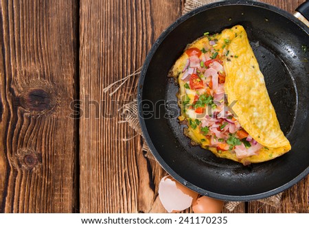 Homemade Ham and Cheese Omelette in a frypan Royalty-Free Stock Photo #241170235