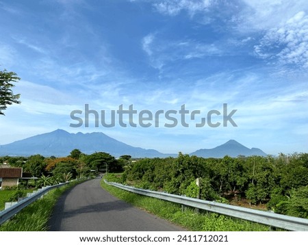The streets in the village with views of the mountains "Arjuno", Mountain "Welirang" and Mountain "Penanggungan"