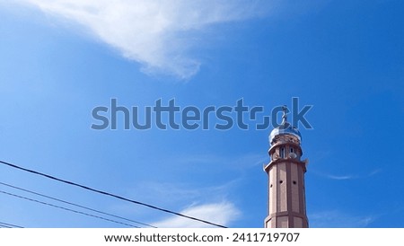 Minaret of Almuttaqin Mosque on the sky. Islamic background mosque. Mosque design in Islamic religious architectural traditions. Creative abstract photography. Ramadhan vibes Royalty-Free Stock Photo #2411719707