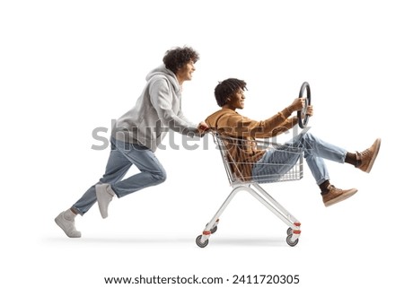 Craze young men riding in a shopping cart isolated on white background Royalty-Free Stock Photo #2411720305