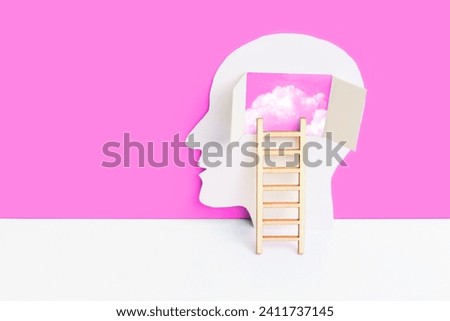 Human head paper cutout and small ladder to the brain area composition set on pink and white backdrop. Understanding and self-discovery concept with a touch of comfort.