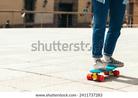 Girl skating in a urban square. close-up