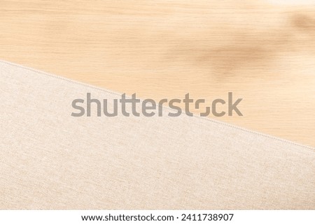 Blank warm lighting background. Fabric and wooden surface. Light and Shadow wallpaper.Space for text. Backdrop. Studio photography. Cozy and Comfortable. Decorative. Minimalist wallpaper. Empty space.