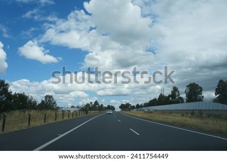 on the road under a blue sky