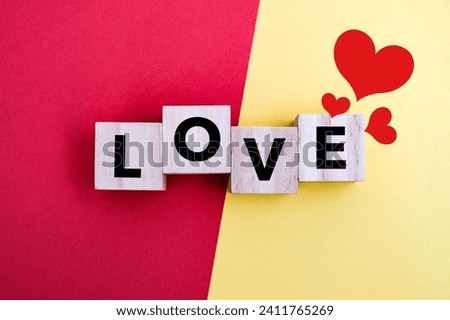 A wooden block with word “LOVE” on it