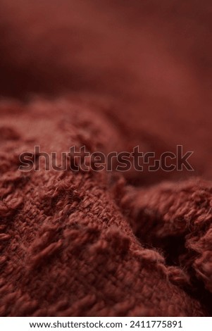detail of the texture of the soft, small-fiber fabric, red or dark red in color