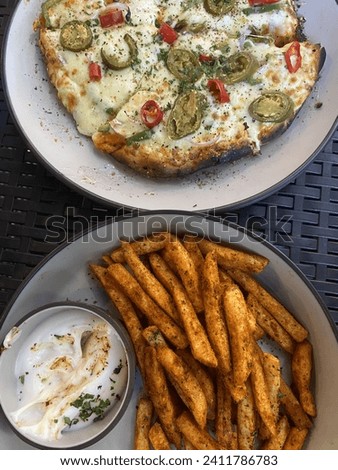 Raw picture of food. Cheesy pizza and perfect crisp potato fries with mayo