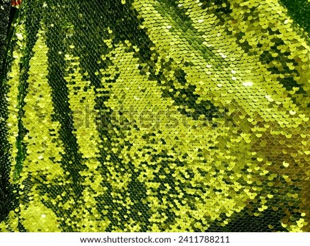 Seamless light green fabric texture with sequins. Sequin fabric texture. Shiny light green sparkling background. Clothing piece of glitter metallic for a glamorous party, celebration. Close-up.
