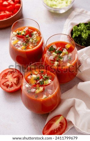 Spanish tomato gazpacho cold soup styled and decorated in glasses Royalty-Free Stock Photo #2411799679