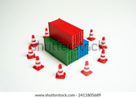 Seizure of cargo. Sea containers are surrounded by road cones and are inaccessible for transportation. Legal or logistical challenges hindering the movement of goods. Shipping complexities disruptions Royalty-Free Stock Photo #2411805689