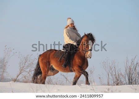 Country girl riding horse in winter farm