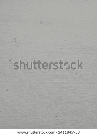 photo of a white wall with holes