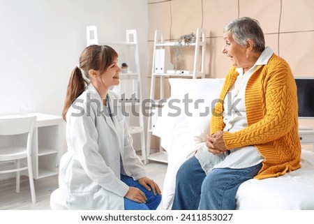 Senior woman with doctor at nursing home