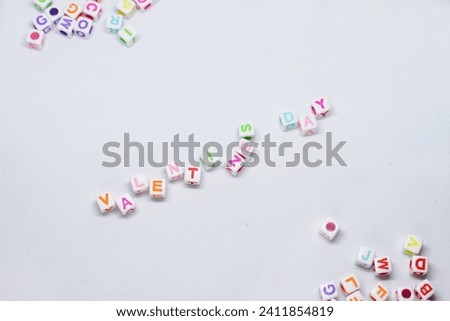 Colored alphabet dice with the word valentine's day isolated on white background.top view.perfect for articles,commercials or anything about valentine's day. Royalty-Free Stock Photo #2411854819