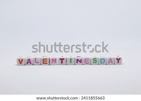 Colored alphabet dice with the word valentine's day isolated on white background.perfect for articles,commercials or anything about valentine's day. Royalty-Free Stock Photo #2411855663