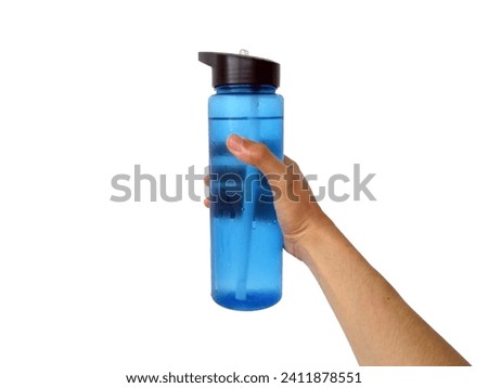 Blue Tumbler drinking bottle in hand filled with cold water isolated on white background