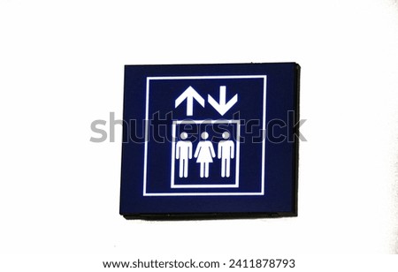 Elevator or lift sign board, with blue and white lines.  There are 2 men and 1 woman in the form.