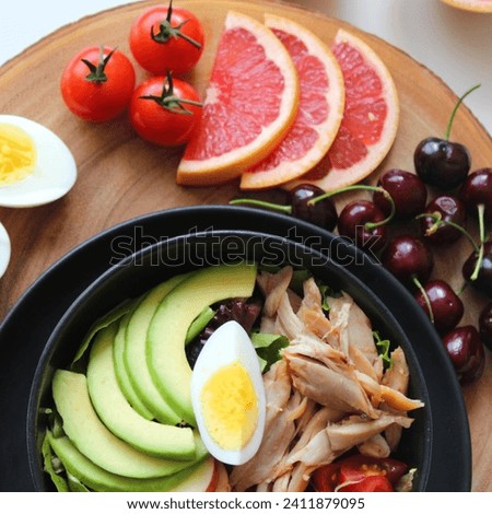 A delicious and nutritious meal can include grilled chicken, creamy avocado slices, a perfectly charred egg, and a burst of citrus flavor from fresh oranges. This combination offers a delightful mix o