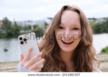 Happy young woman exercising photographed using a mobile phone camera